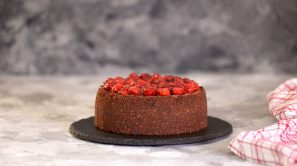 Delicious Homemade Chocolate Cheesecake Decorated With Cherry Sauce.