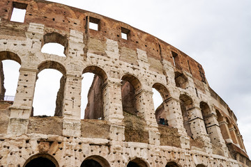 Fototapeta premium ancient Colosseum against sky with clouds in rome