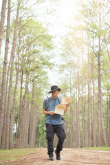 Asian man with backpack hiking in forest , Adventure Travel Remote Relax Concept