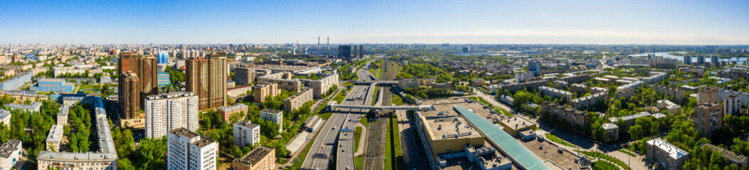 Aerial top view of road junction in Moscow from above, automobile traffic and the old Ugreshskaya railway station in the Moscow industrial zone near the automobile ring highway