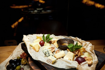 a dish of french cheese with mold, walnuts, mint and honey