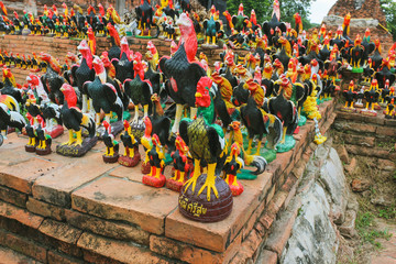 Traditional buddhist statues of cocks at a wat (temple) in Ayutthaya, Thailand
