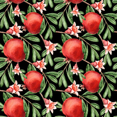 seamless background, red pomegranate on a branch with green leaves and flower bud against a dark background