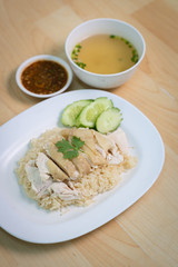 Steam Chicken with Rice (Hainan Chicken) on wooden table