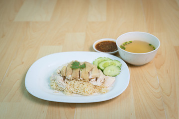 Steam Chicken with Rice (Hainan Chicken) on wooden table