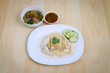 Steam Chicken with Rice (Hainan Chicken) on wooden table