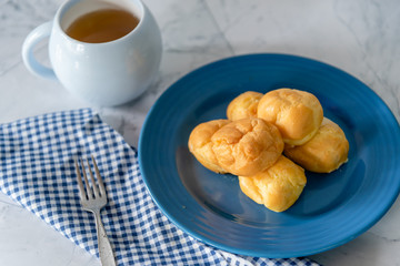 Choux cream as cream puff with tea for breaking time dessert or afternoon tea on white background