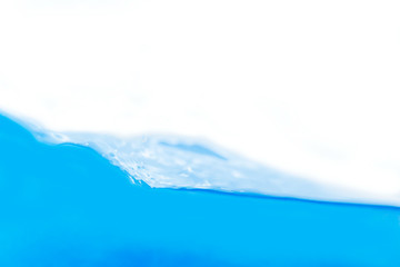 Water splashed separately on a blue surface