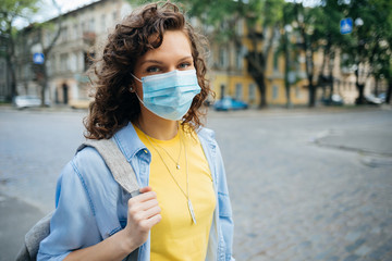 Young woman wearing medical mask for protection against the virus