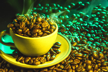 Coffee cup and coffee beans on table background. Top view with copy space for your text