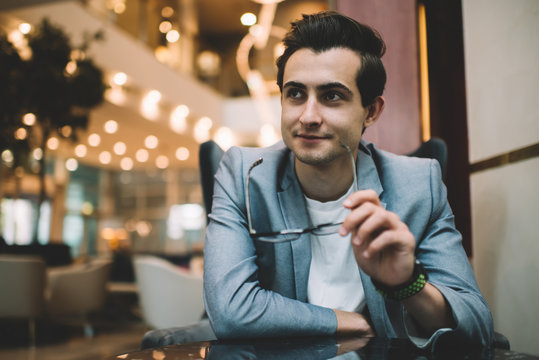Young man sitting at table in cafe