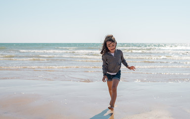 Young girl enjoying the beach on a beautiful sunny day