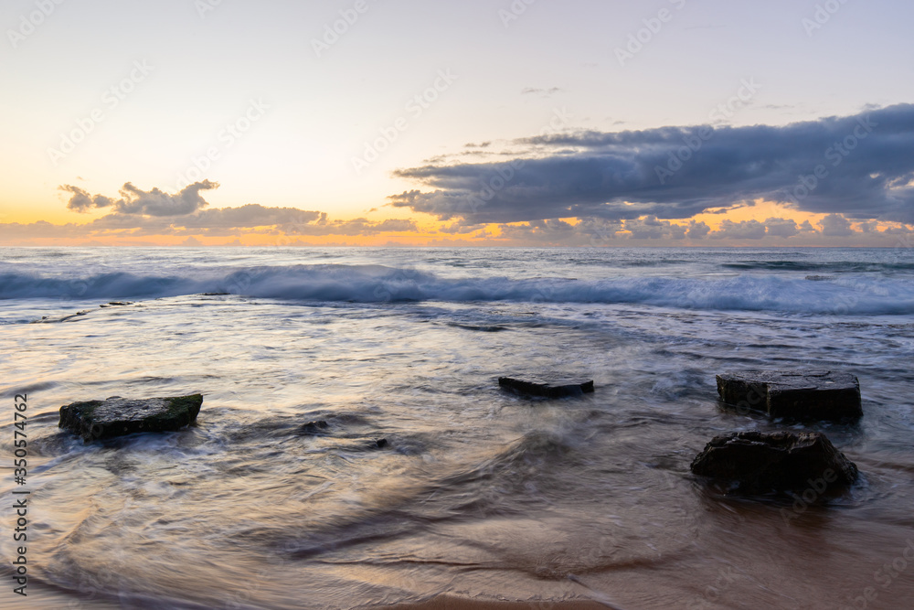 Wall mural rocky coastline in the morning at turimetta beach, sydney, australia.