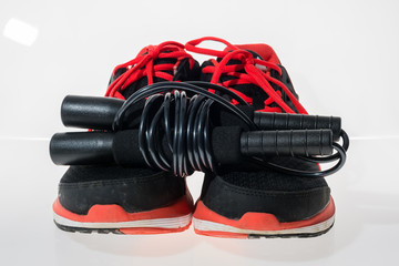 Used lack and pink fitness sneakers with jumping rope.