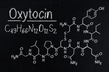 Black chalkboard with the chemical formula of Oxytocin