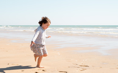 Young girl enjoying the beach on a beautiful sunny day