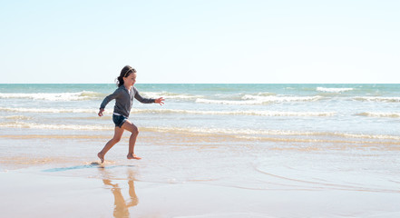 Fototapeta na wymiar Young girl enjoying the beach on a beautiful sunny day