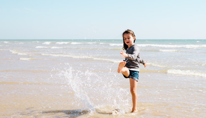 Young girl enjoying the beach on a beautiful sunny day