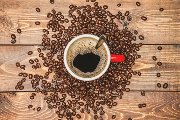 Coffee cup and beans on a wooden table background Top view with copy space for your text