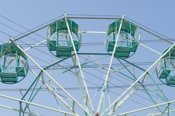 Blurred green ferris wheel in the park