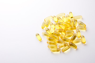 Many omega 3 capsules are isolated on a white background