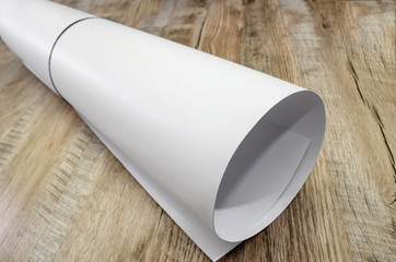 rolled up white whatman  on a wooden table