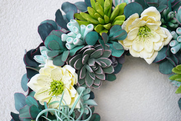 A beautiful flower wreath made of succulents on a white background