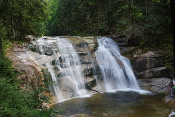 Flowing stream with a waterfall in nature