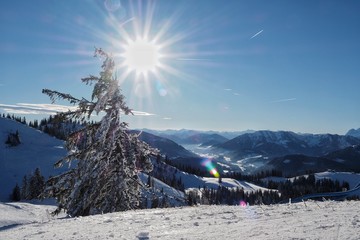 Sunlit snowy mountains in the ski resort Dachstein west