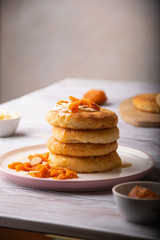 a stack of delicious cheesecakes with sauce and fruit on a plate