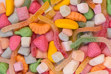 Colorful jelly in different shapes, view from the top. Sweetmeats and confectionery for birthday party. Multicolored jelly and sweets, close up, medium sharp