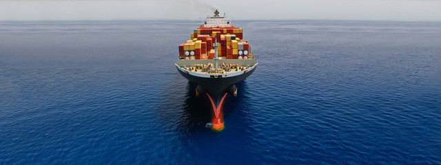 Aerial drone panoramic ultra wide photo of industrial container tanker ship cruising in open ocean...