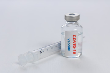 Covid-19 or coronavirus vaccine vial and syringe on white background.