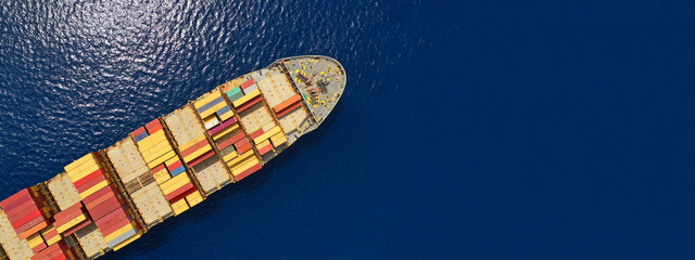 Aerial drone panoramic photo of industrial container tanker cruising in open ocean deep blue sea	
