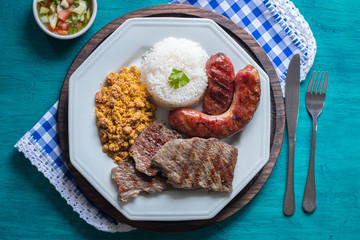 Food plate with barbecue. Brazilian food. Seen from above.