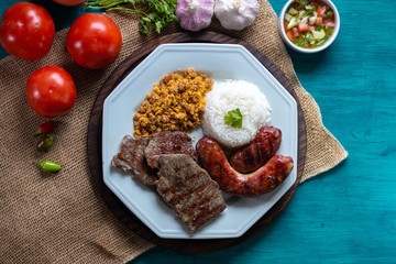 Food plate with barbecue. Brazilian food. Seen from above.