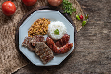 Food plate with barbecue. Brazilian food. Seen from above.