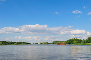 Panoramic view with beautiful blue sky and clouds on the lake near Nesvizh castle. Postcard concept