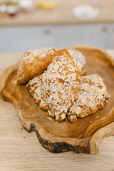 Almond croissants on a wooden plate. Coffee shop concept.