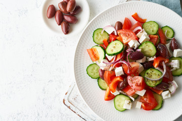 Greek village salad horiatiki with feta cheese, olives, cherry tomato, cucumber and red onion