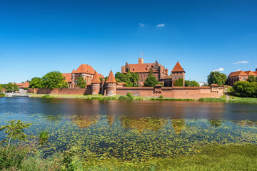 Fototapeta na wymiar Teutonic Castle in Malbork or Marienburg at summer in Poland