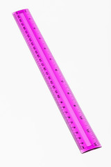 plastic pink ruler on white background