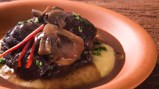 Slide shot Ossobuco with polenta. Smoke.