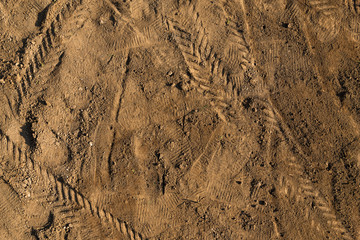  sand texture with traces of shoes and tires