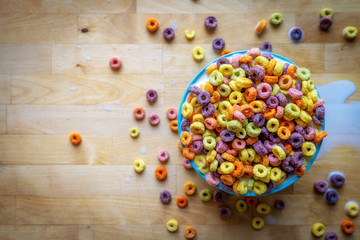 Colourful bowl of cereal on wooden table top, flat lay. - Powered by Adobe