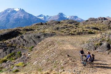 Fototapeta premium Tourists looking to the sunset in the mountains at Chilean Patagonia - Chile Chico, Aysén, Chile
