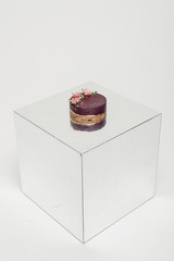 Cake in the photo studio. Purple cake. Cake on the mirror. 