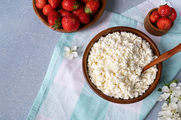 cottage cheese with strawberries in a wooden bowl. Healthy breakfast