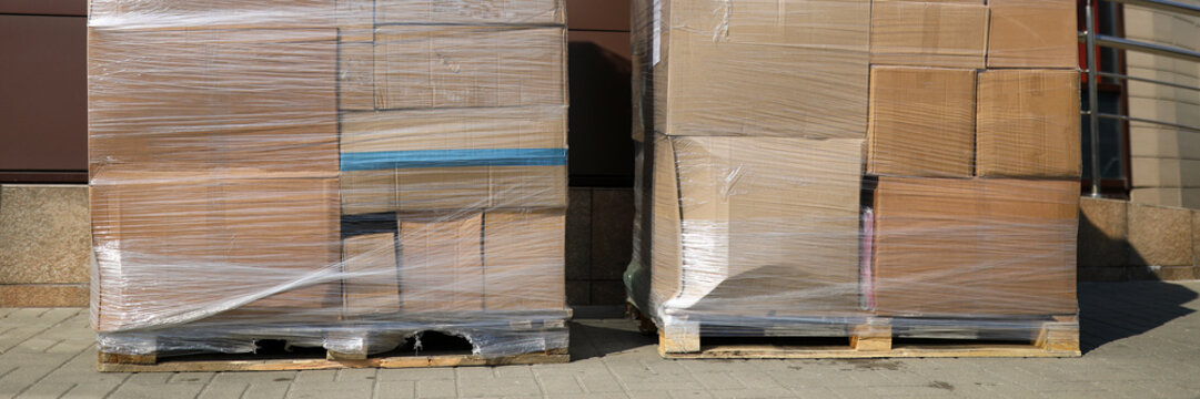 On city street are pallets with boxes in film