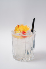 Making cocktails at home like an expert nightclub barman. Fresh and juicy colorful homemade cocktails garnished with berries, orange, mint and coffee on white background.